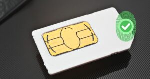 Close-up of a SIM card with a fingerprint and checkmark icon, representing biometric SIM registration in Ghana